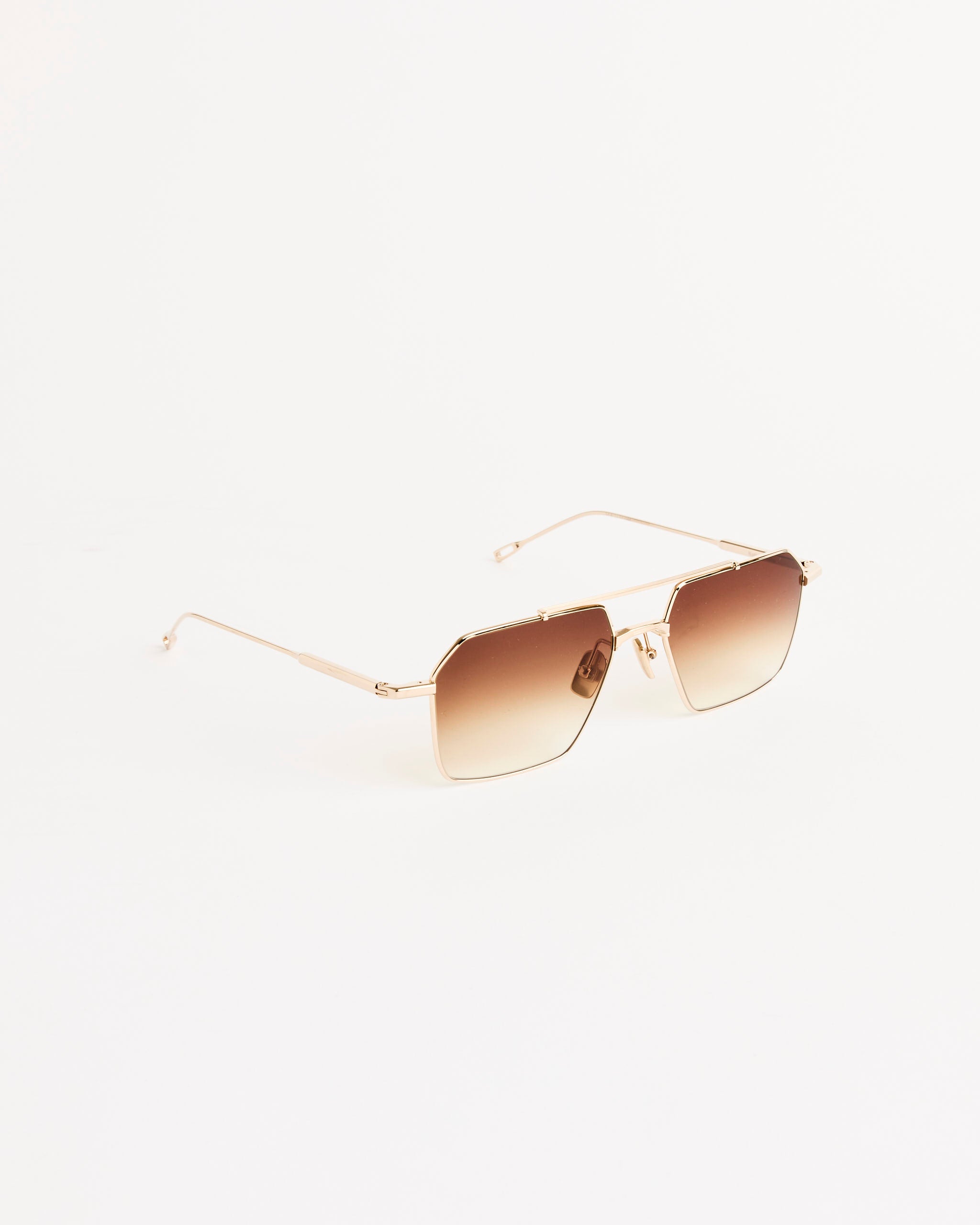 The Native Sons Remm 55 Sunglasses in 16K Gold/Spice Brown Gradient feature geometric titanium frames and UV-protective sun lenses, stylishly displayed on a plain white background.