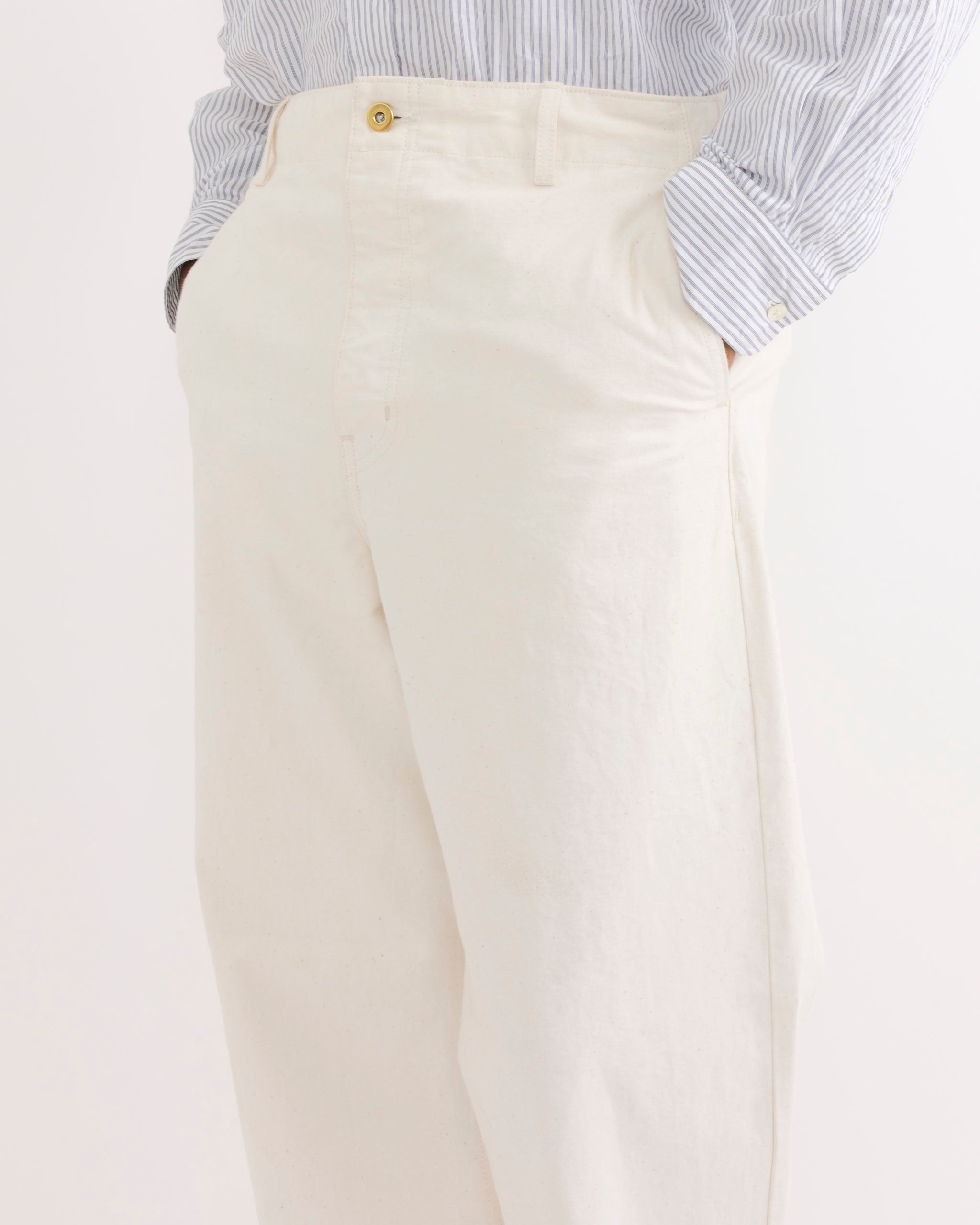 Model wears the SMOCK Officer Trouser in Washed Pigment Dyed Cotton Natural, hands in pockets, shown from waist to mid-thigh against a plain background—ideal for viewing fit and sizing before your next purchase.