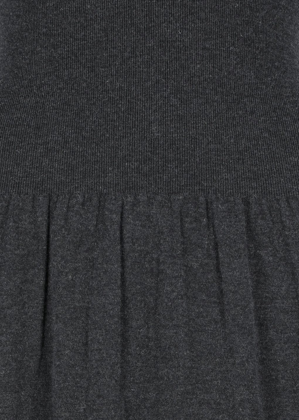 A close-up of the Amomento Shirring Knit Maxi Dress in Charcoal showcases the ribbed texture at the top and the gathered, pleated fabric below, emphasizing the elegant detailing of this design.