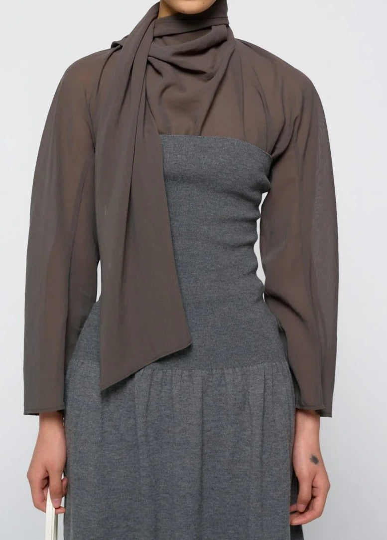 A person wearing the Amomento Sheer Cotton Scarf Top in grey with a matching scarf over a gray strapless dress, standing against a plain background.