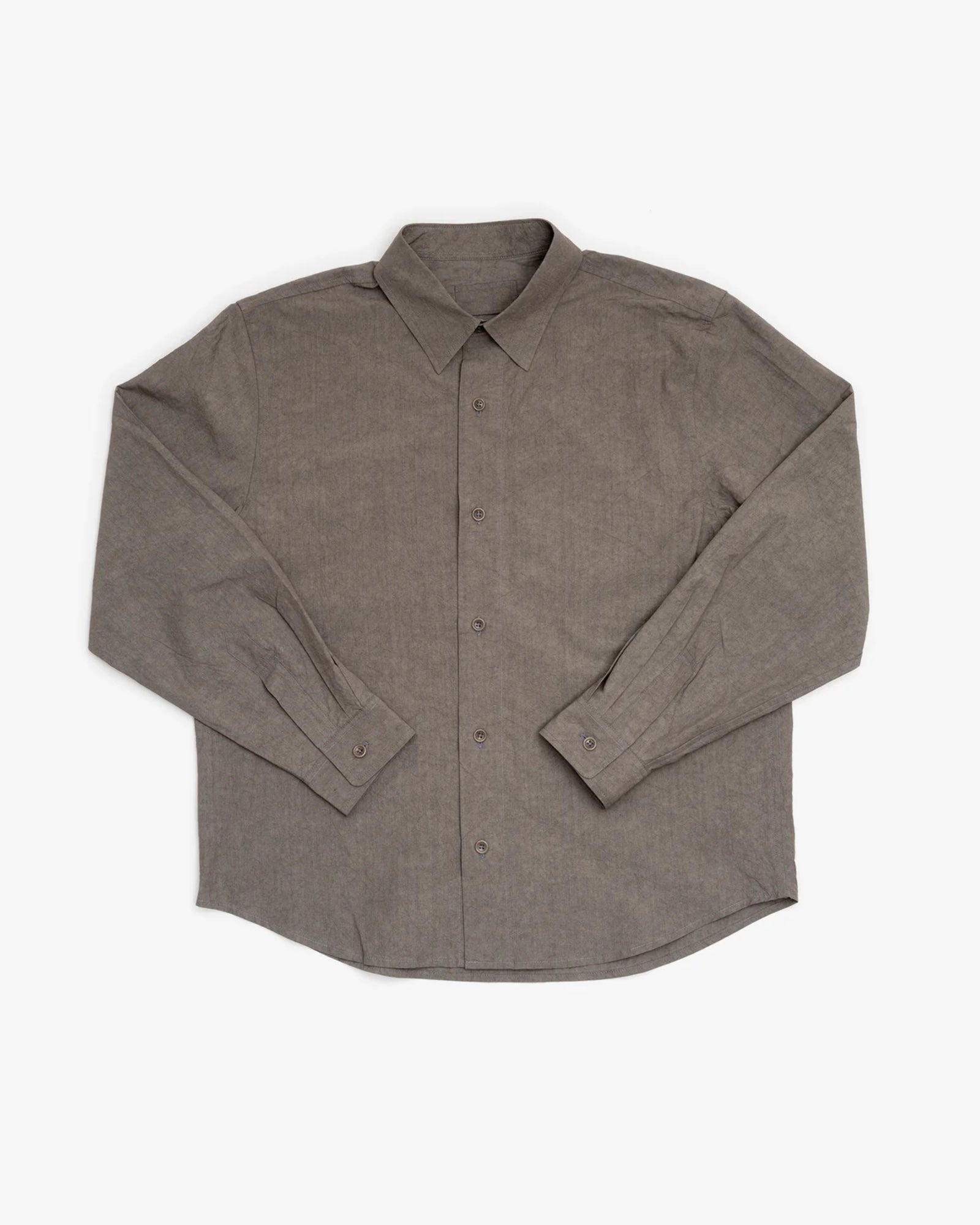 The James Coward Filter Shirt in Grey is a long-sleeve, button-up shirt with a pointed collar and buttoned cuffs, crafted from Japanese typewriter cloth and shown laid flat on a white background.