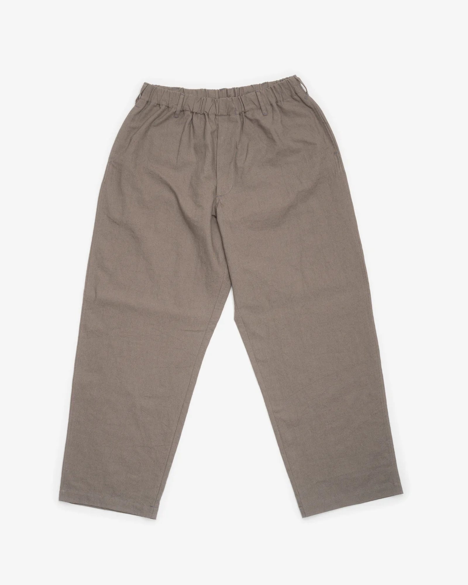 Loose-fitting, straight-leg James Coward Carry On Pant in mid grey Japanese canvas with an elastic waistband, displayed flat on a white background.