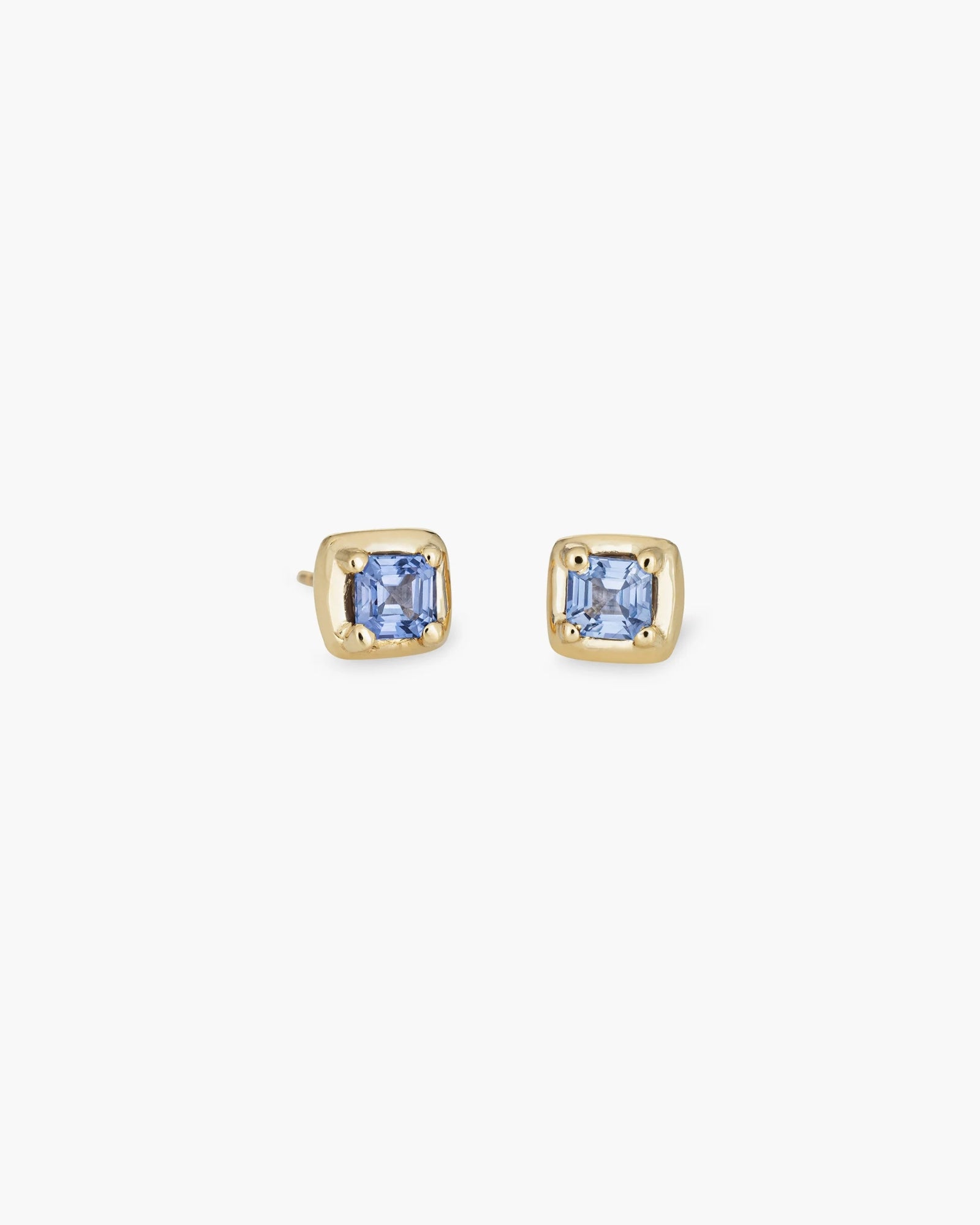 The Kathryn Bentley Square Studs Pair are handmade earrings with light blue sapphire accents set in elegant 14K yellow gold.