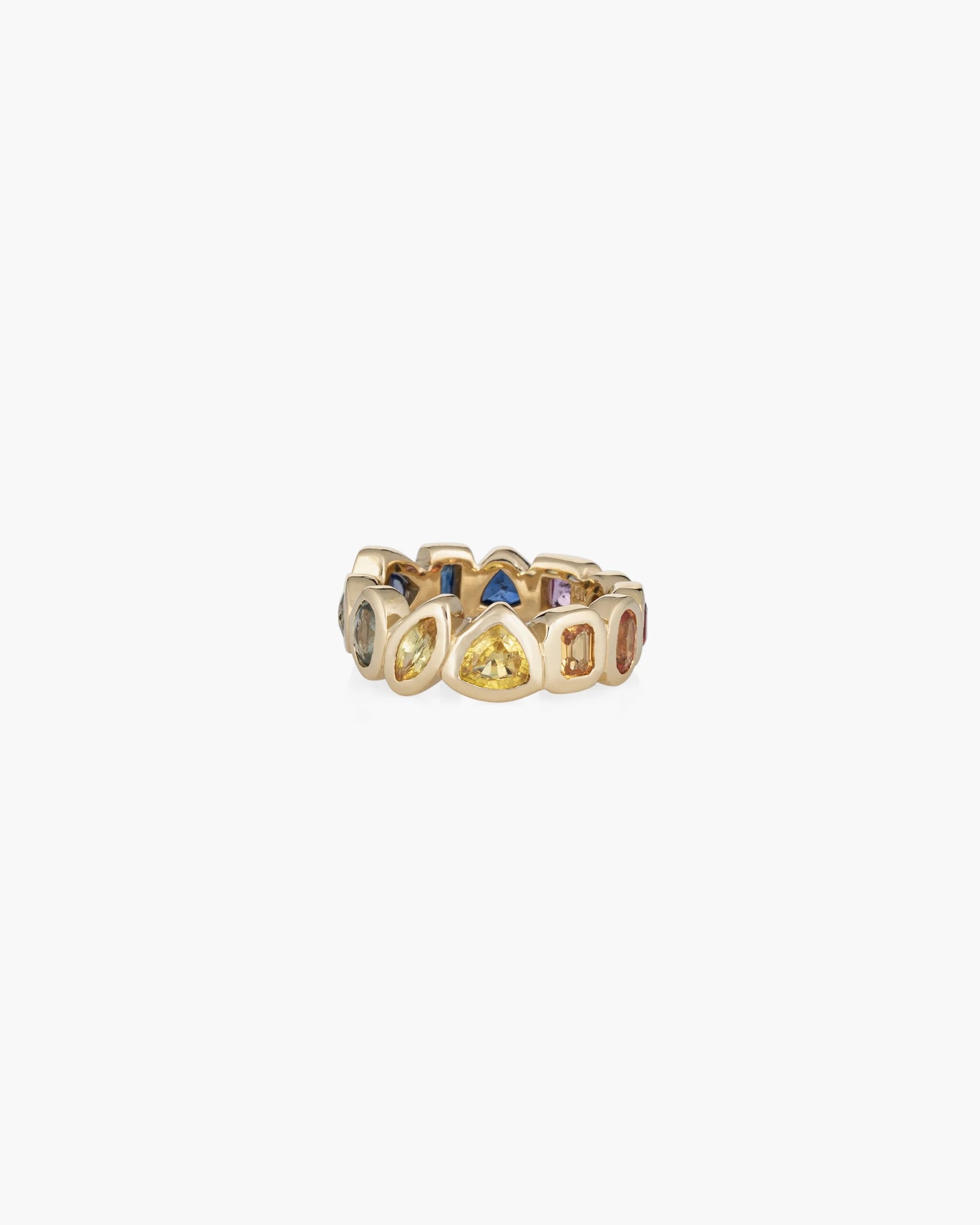 The Confetti Band by Kathryn Bentley is a handmade 14K gold ring with bezel-set, irregular multi-colored sapphires in a continuous band design.