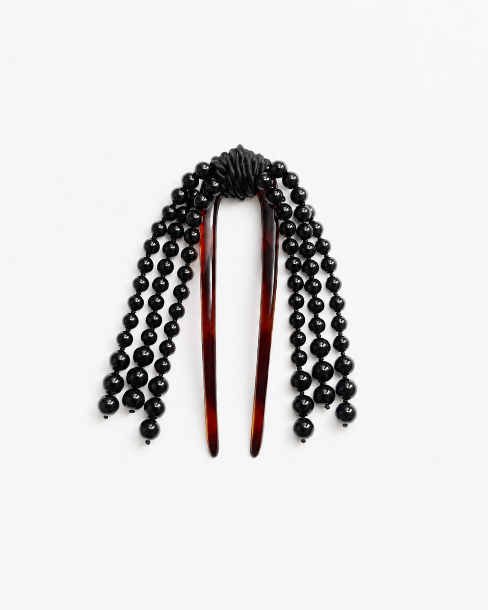 The Cande Hair Comb in Black Jade by Mosquito features two brown prongs and black beaded strands cascading from the top, beautifully displayed on a white background.