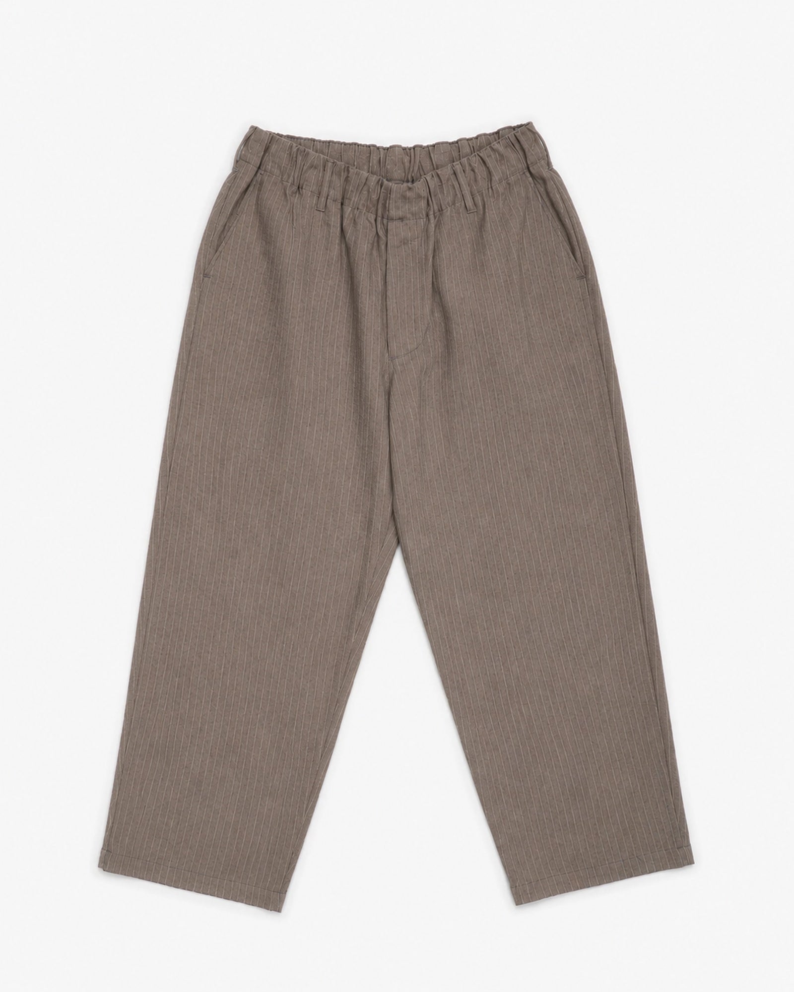 The James Coward Carry On Pant in Dark Brown features a wide-leg, relaxed trouser fit with an elastic waistband and side pockets, shown flat on a white background.
