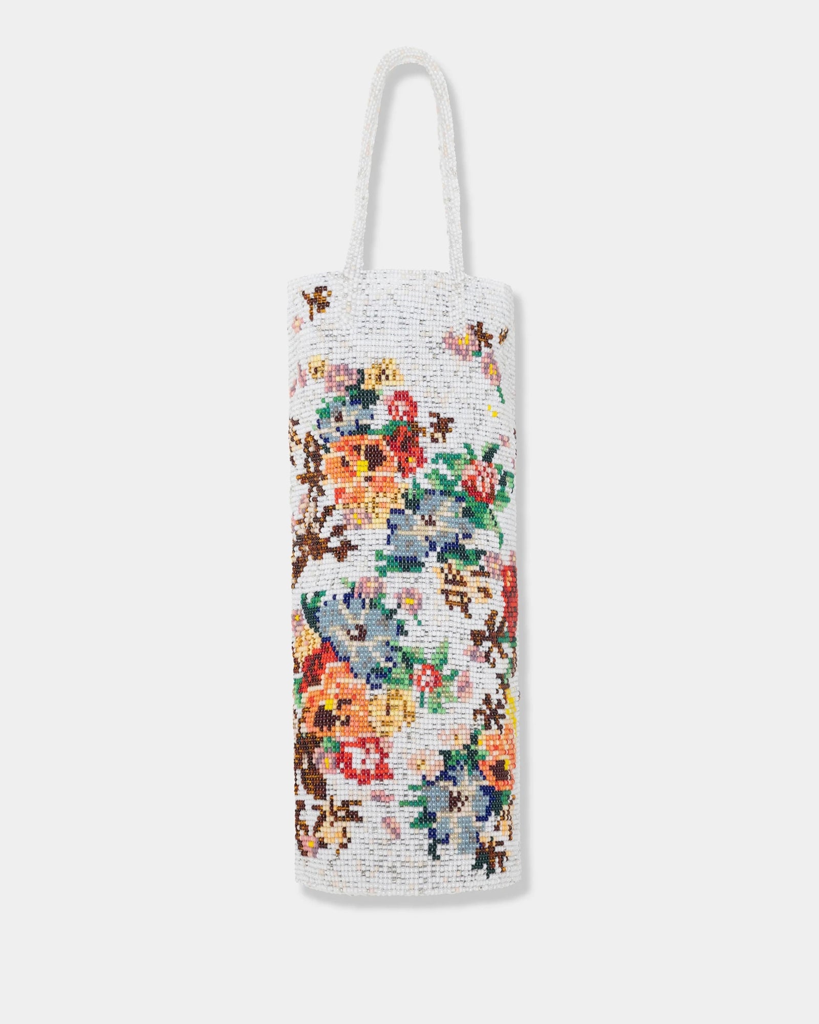 The Handmade Beaded Bag in Marigold by CORDERA is a white rectangular handbag featuring a single handle and adorned with vibrant floral and leaf motifs in a pixelated cross-stitch style, creating the look of an artisanal piece crafted from delicate acrylic beads.