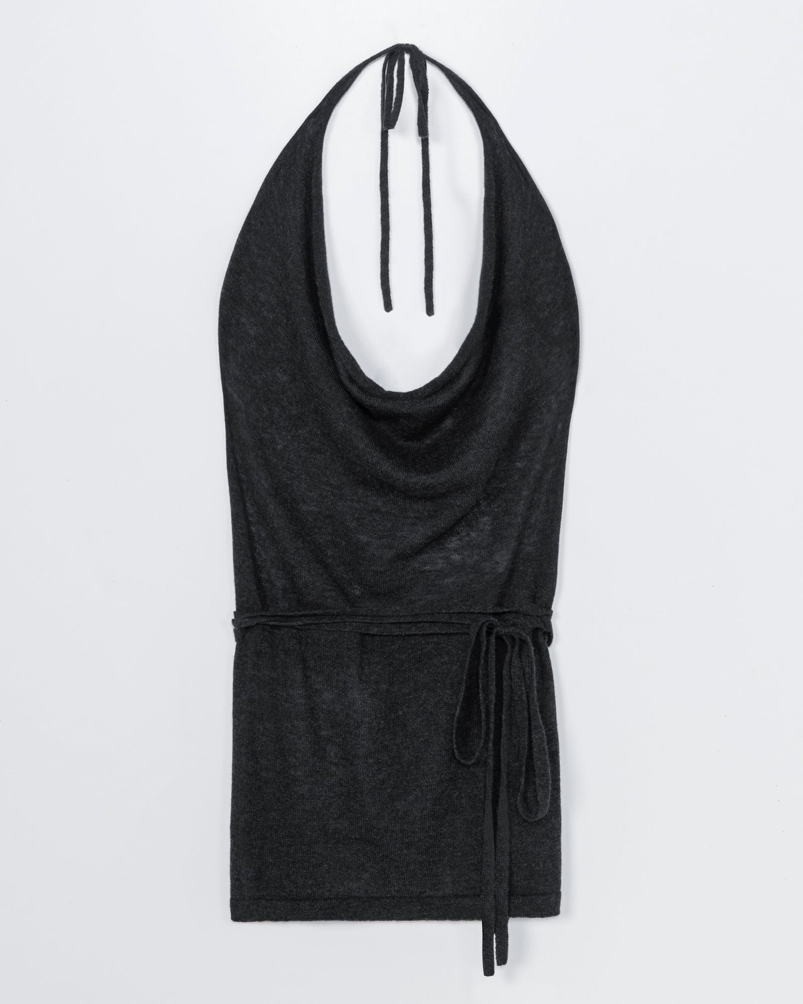 The CORDERA Merino Wool Tie Top in Anthracite is a sleeveless halter with a draped neckline and waist tie, shown flat on white—ideal for an effortless fit. Chat online for sizing help.