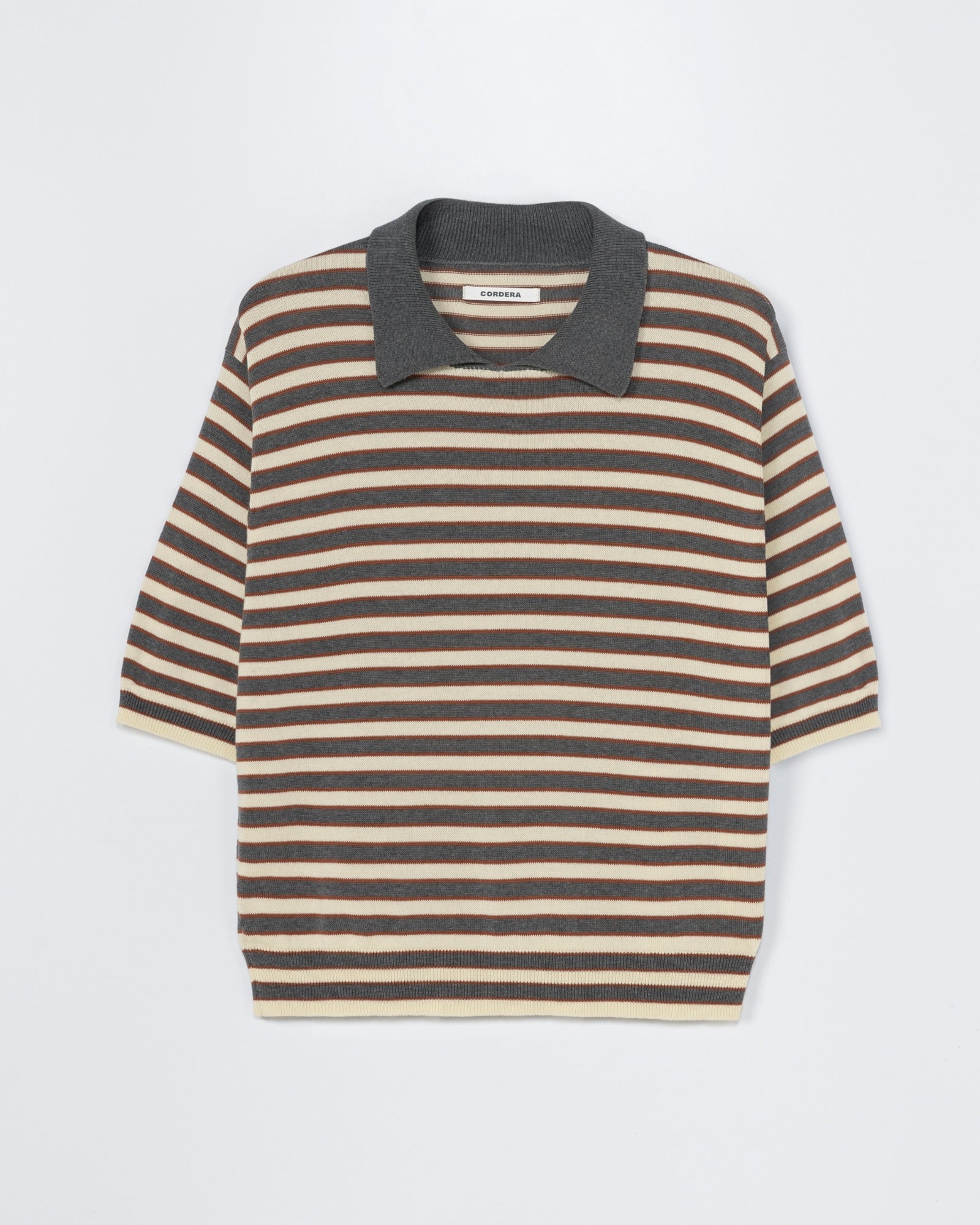 The CORDERA Organic Cotton Striped Polo in Grey features short sleeves, brown, beige, and cream stripes, and a contrasting dark gray collar. Laid flat on a light background. Chat with us online for fit or sizing questions.