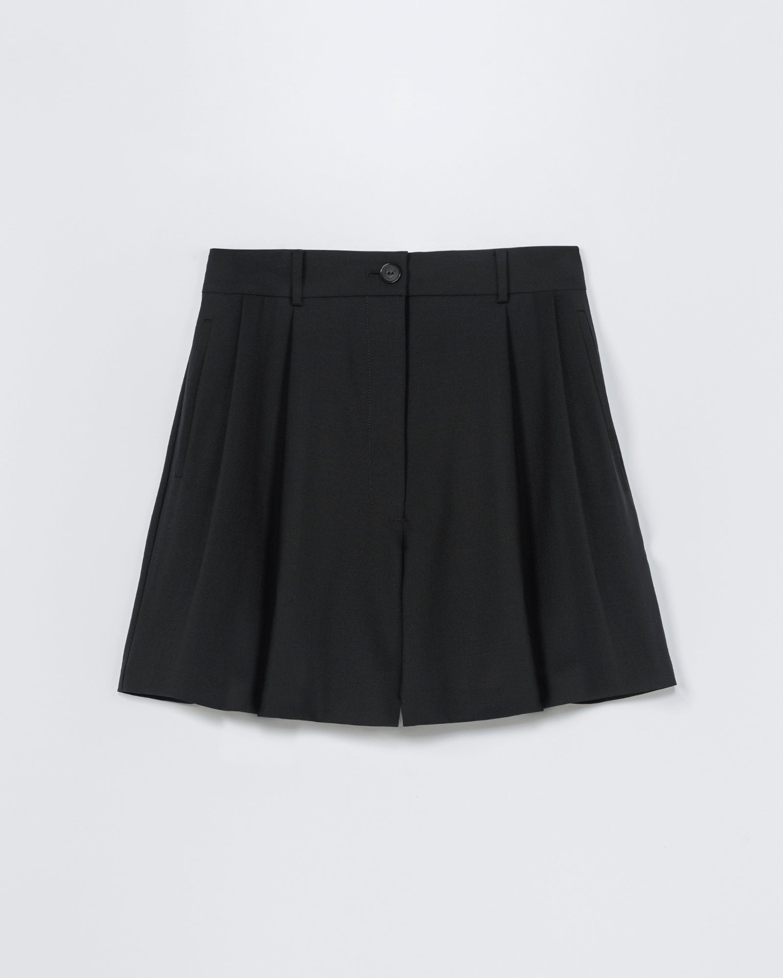 The CORDERA Tailored Bermuda in Black features pleats, a button and zipper closure, belt loops, and a tailored fit. Shown on a white background. For sizing help, use our online chat to find your perfect match.