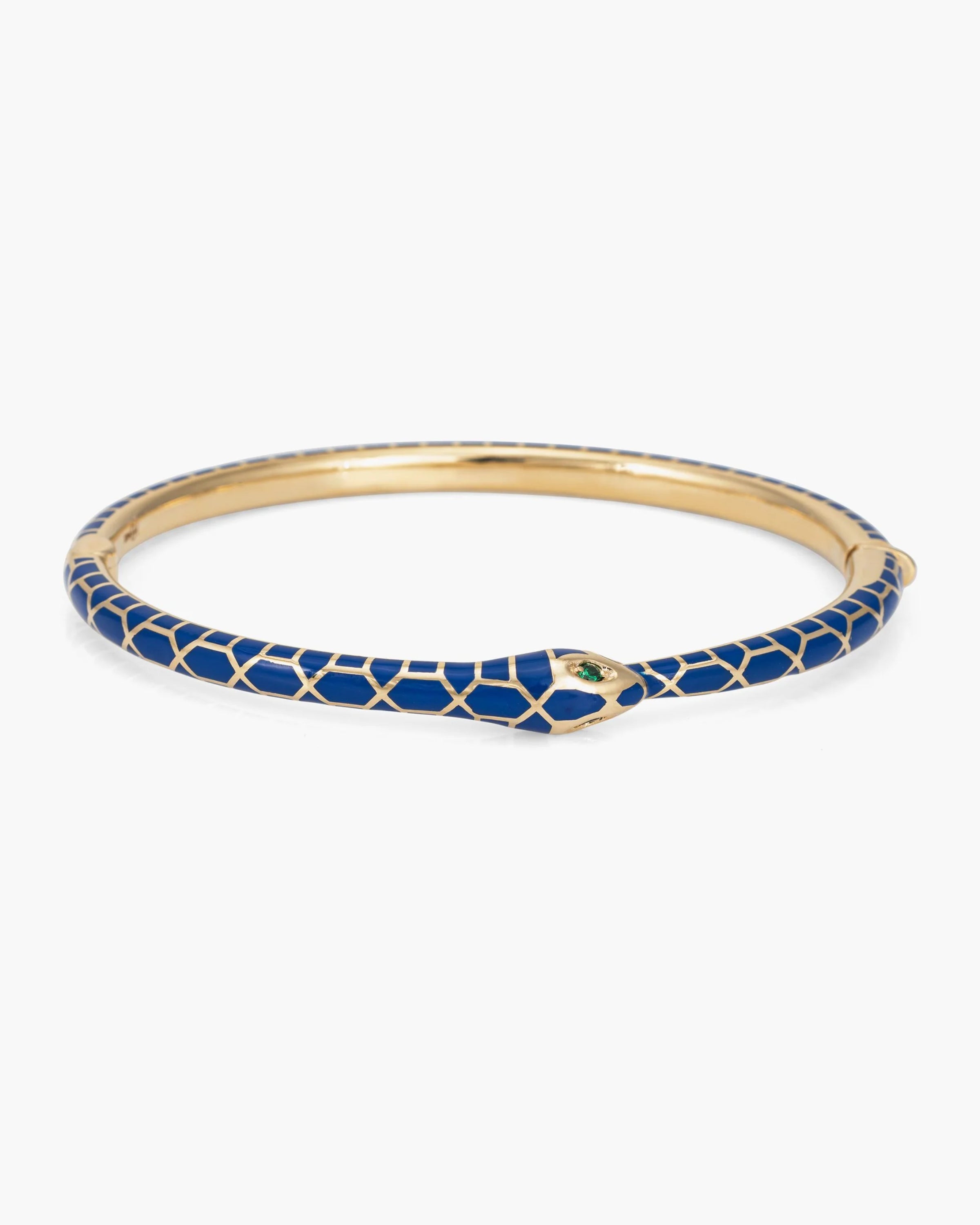 The Kathryn Bentley Ouroboros Snake Emerald Eyes Bracelet is crafted in 14k yellow gold with a blue enamel scale pattern and vivid green emerald eyes.