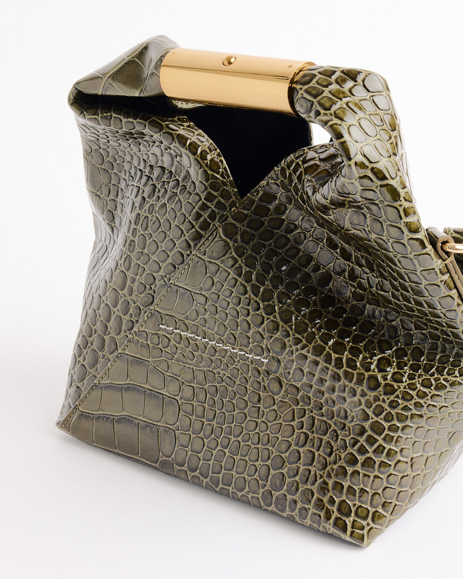 The MM6 Maison Margiela Japanese Small Bag in Olive is a structured, olive green leather shoulder bag with a crocodile print and gold metal handle, shown on a white background.