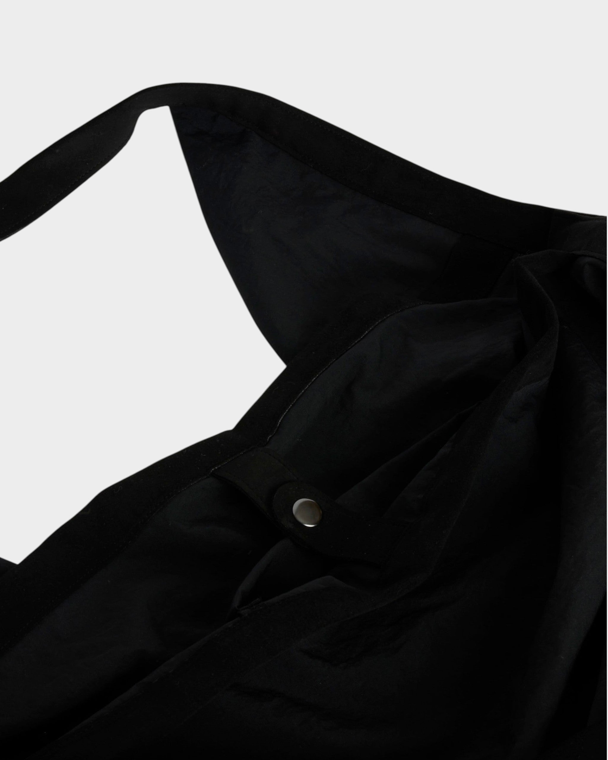 Mohawk General Store black nylon tote bag featuring a snap button closure and wide shoulder strap