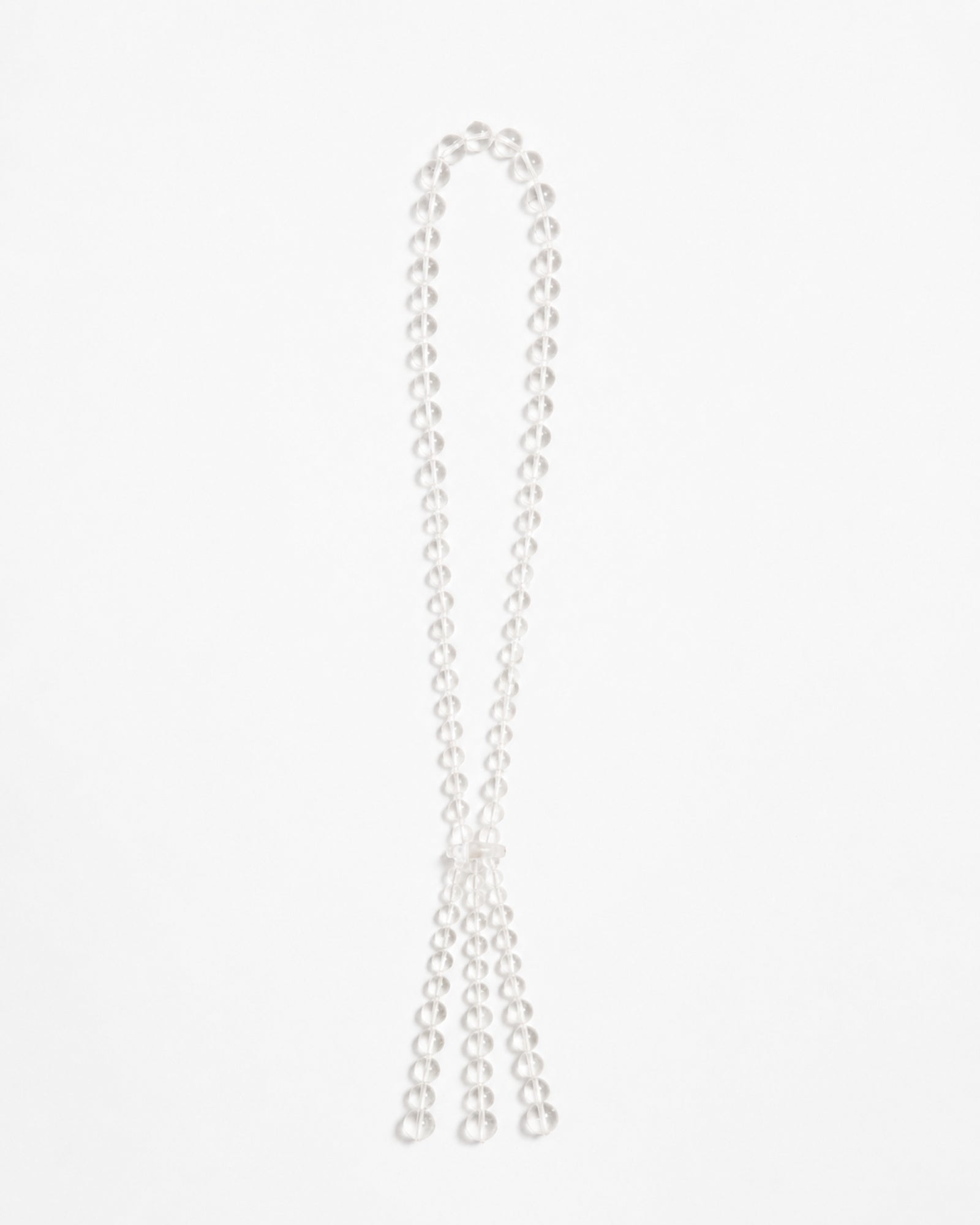 The Pipa Necklace by Mosquito is a long, double-stranded pearl necklace, arranged in a loop with the two ends elegantly hanging down against a plain white background.