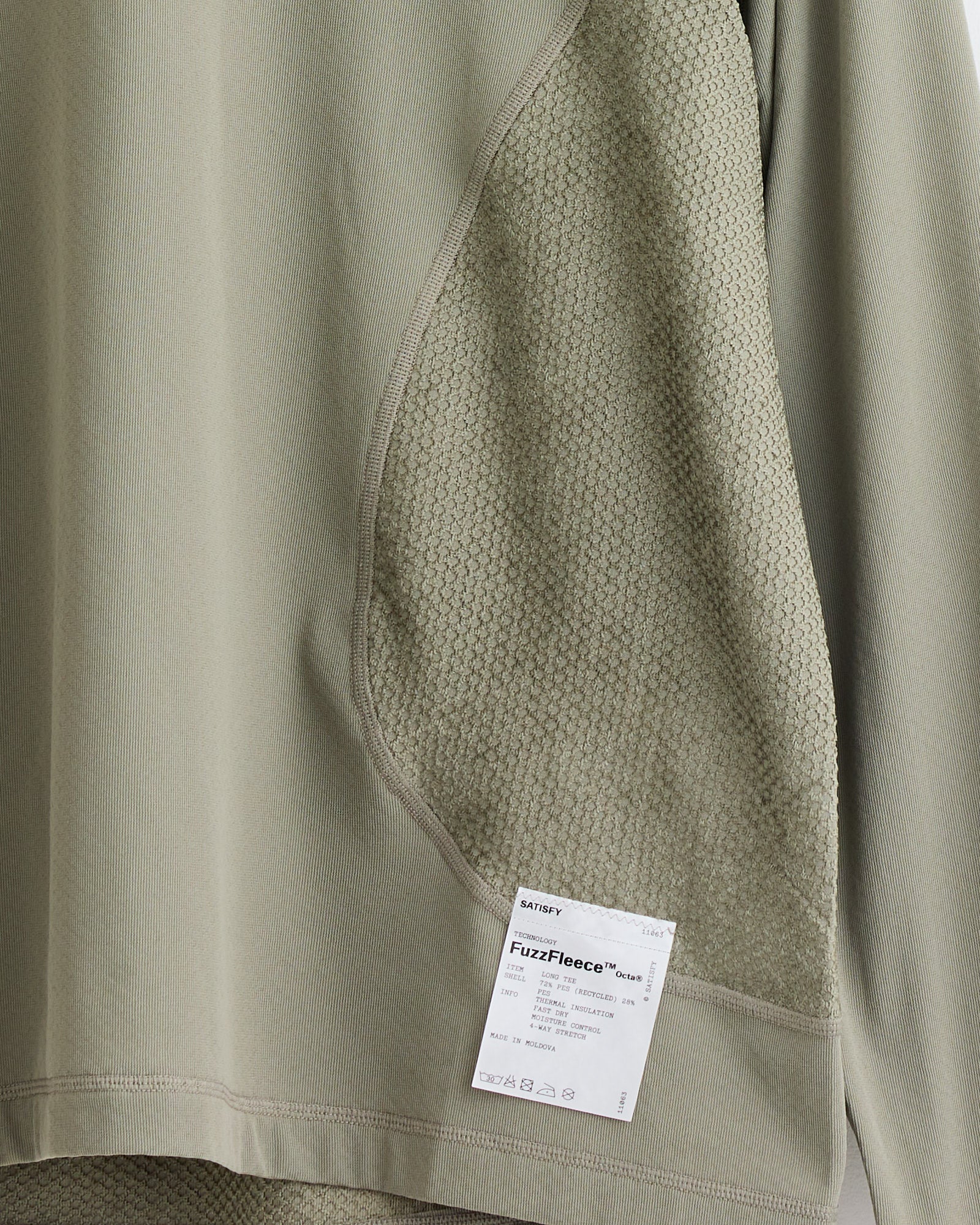 The Satisfy Running FuzzFleece Octa L/S T-Shirt in Vetiver is a light olive-green fleece with textured side panels and a white FuzzFleece label by the hem. For fit or sizing questions, contact us via online chat.