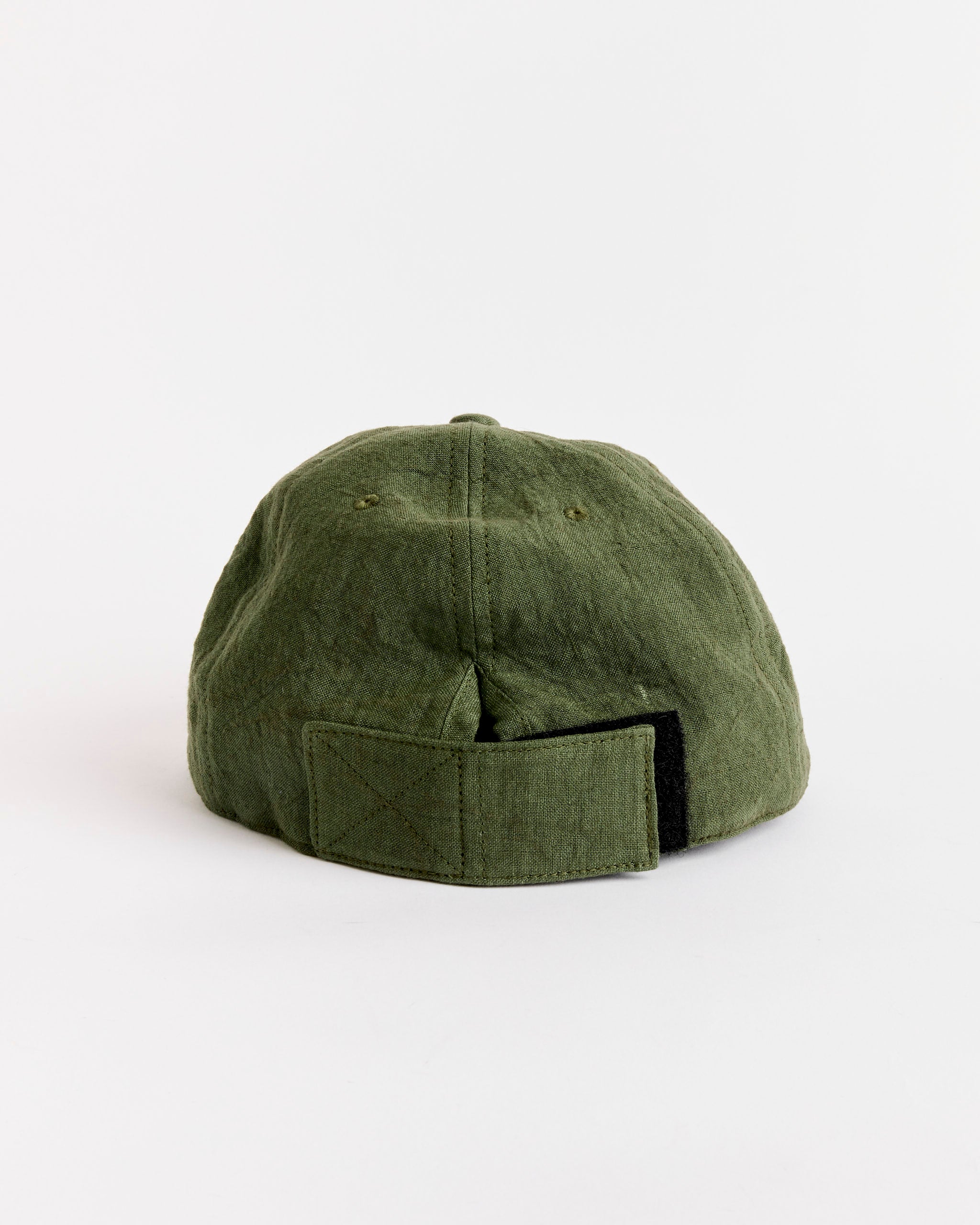 The SMOCK Velcro Back Cap in Sun Dried Linen Green is displayed from the back, showing its adjustable Velcro strap, set against a plain white background.