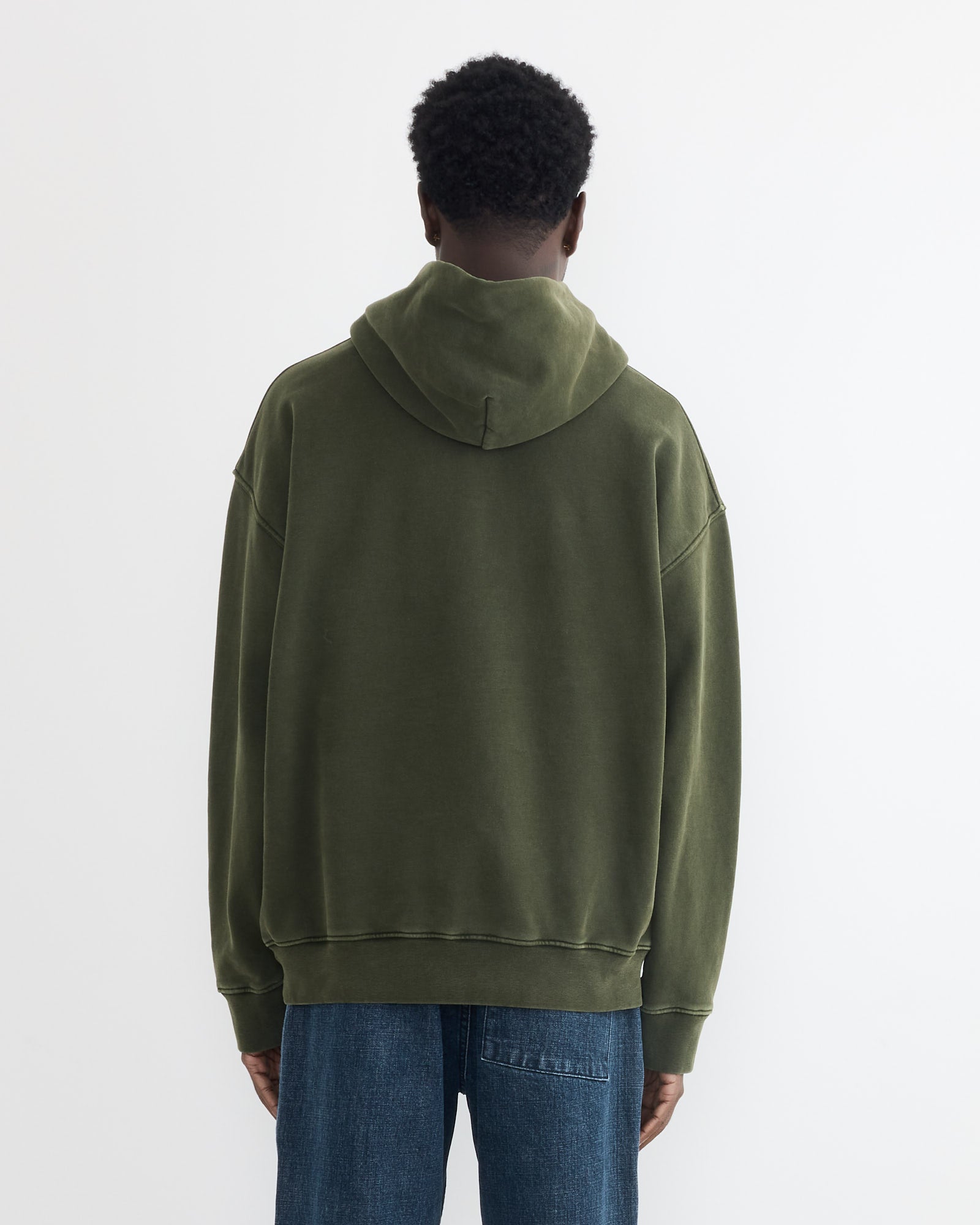 Model wearing a SMOCK green hoodie on a white background.