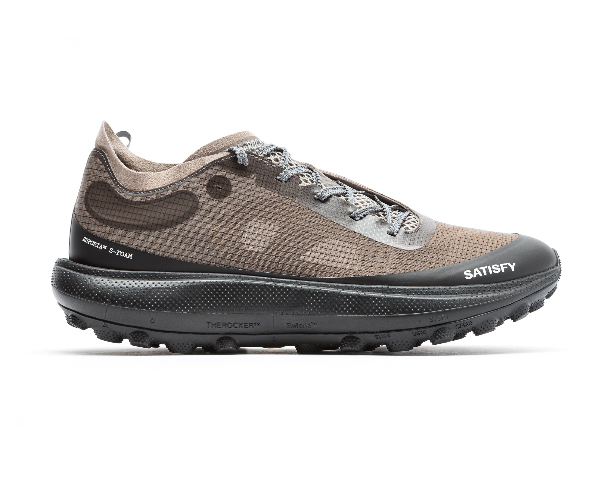 The Rocker in Falcon by Satisfy Running is a brown and black trail shoe with a grid-patterned upper, thick black Vibram Megagrip sole, gray laces, and SATISFY branding with technical details on the side, shown on a white background.