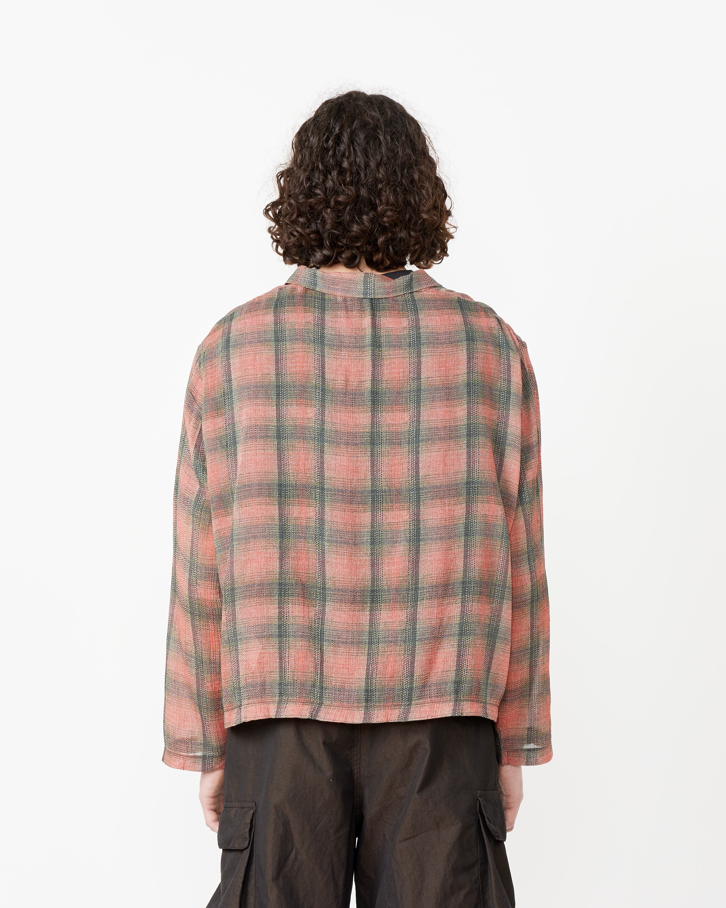 Person with curly hair wearing the Our Legacy Shrunken Fullzip Polo, shown from the back against a plain white background.